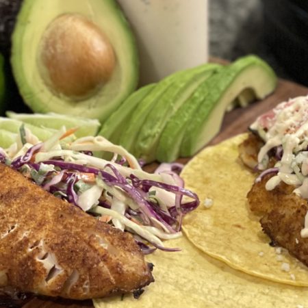 Fish Tacos on a Cutting Board with the Condiments