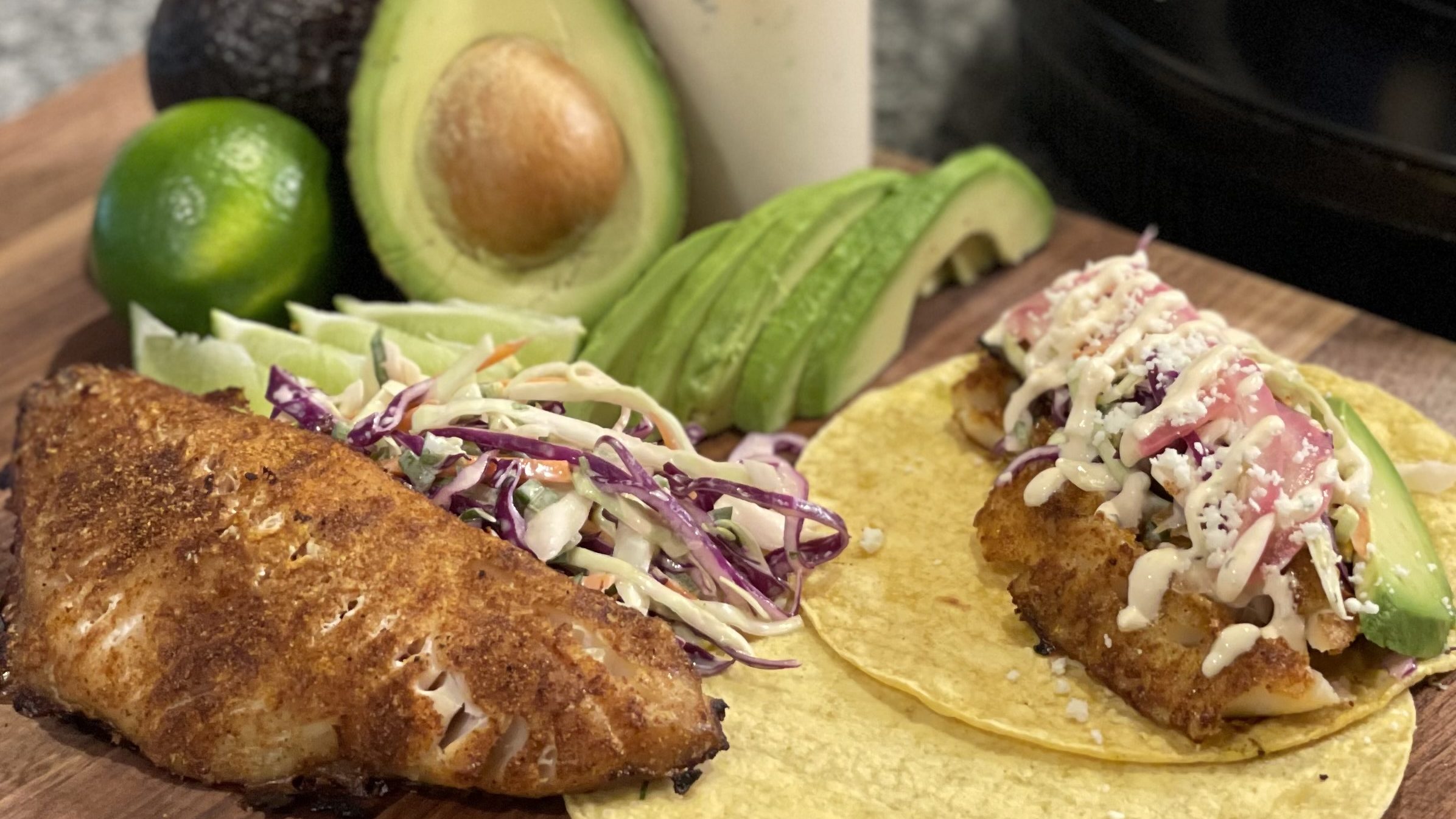 Fish Tacos on a Cutting Board with the Condiments